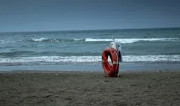 A lifebuoy on the beach.