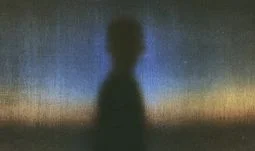 silhouette of a man against a blueish background