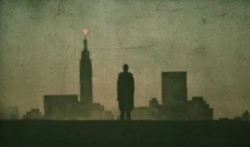 silhouette of a man looking at Manhattan 