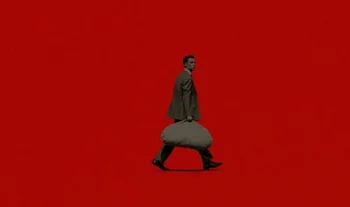 banker carrying a bag of money against a red background
