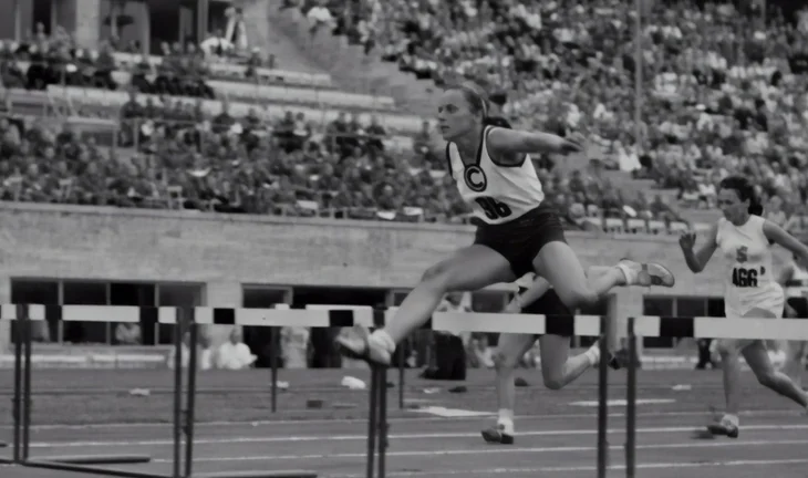 woman jumping a hurdle 