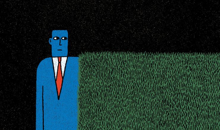 man next to hedge